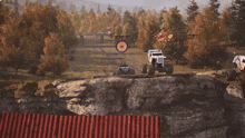 two monster trucks are driving on a rocky road with a target in the distance