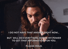 a man with a beard is talking on a phone