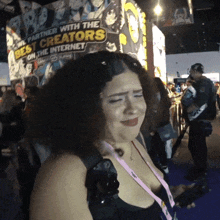 a woman is standing in front of a sign that says " we partner with the best creators on the internet "