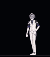 a man in a tuxedo is dancing on a stage .