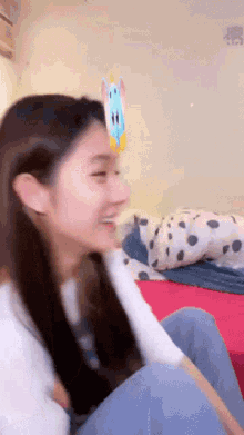 a girl with a unicorn sticker on her head