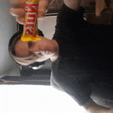 a woman is holding a snickers bar in her hands