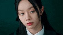 a close up of a woman 's face wearing a school uniform .