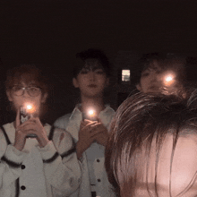 a group of people holding candles in their hands