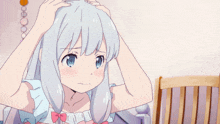 a girl with white hair and a pink bow on her head is sitting in a chair