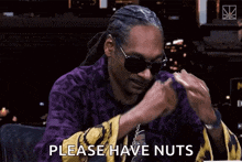 snoop dogg is wearing sunglasses and a purple robe and is asking for nuts