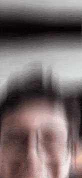 a blurry picture of a person 's face with glasses on