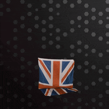 a british flag hangs on a black wall
