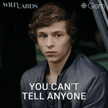 a young man sitting in a car with the words " you can 't tell anyone "