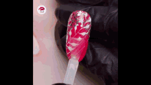 a person is applying nail polish to a nail with a brush .