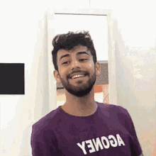 a man with a beard wearing a purple shirt that says yеиоза