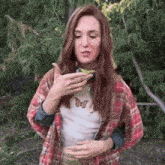 a woman in a plaid shirt with a butterfly on her shirt