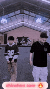 a man wearing a jersey with the number 89 on it walks next to another man