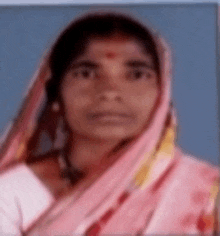 a blurry picture of a woman wearing a pink scarf on her head