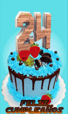 a birthday cake with blue frosting and strawberries and the number 24 on top