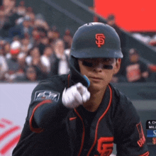 a san francisco giants baseball player is pointing at the camera