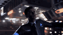 a man in a suit and tie with rk800 written on his chest