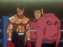 a man in a pink jacket with chinese writing on the back stands in a boxing ring with two other men