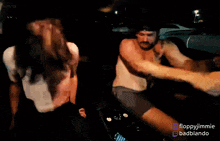 two shirtless men are dancing in a car with the words floppyjimmie badbiando on the bottom right