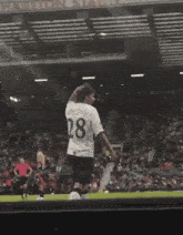 a soccer player with the number 13 on his shorts is hugging another player