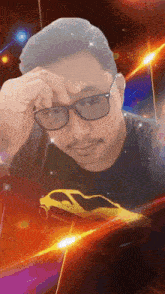 a man wearing glasses and a black shirt with a car on it