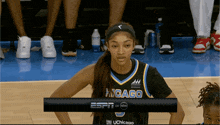 a female basketball player wearing a jersey that says indago on it