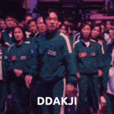 a group of people standing in a line with the words " red light green light " on the bottom