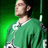 a man in a green jersey with the letter g on the front