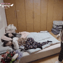 two girls laying on a bed with a sign that says nxt & glow on it