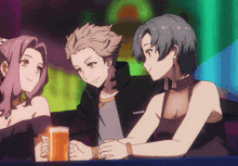 a man and two women are sitting at a table with a beer