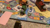 a thomas the train game is being played on a rug .