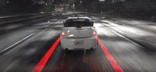 a white car is driving down a highway with a california license plate that says qwk53