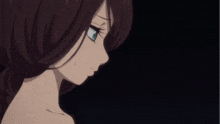 a woman with brown hair and blue eyes is looking down