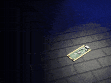 a piece of electronic equipment is laying on a brick floor