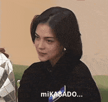 a woman wearing a black sweatshirt says mikado