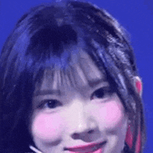 a close up of a woman 's face with a microphone in her hair .