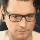 a man wearing glasses is making a funny face .