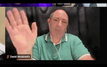 a man in a green shirt is on a video call with david moskowskitz