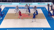a group of volleyball players are playing on a court with a sign that says regioneemilia romagna