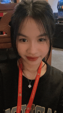 a girl with a lanyard around her neck that says ' aasia '