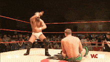 two men are wrestling in a ring with the word wc on the bottom