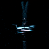 a woman in a plaid shirt is standing in a blue light