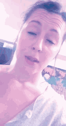 a close up of a woman 's face with her eyes closed and her mouth open