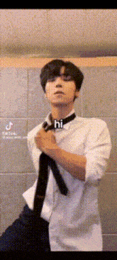 a man in a white shirt and tie says hi on his neck