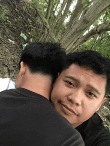 a man 's head rests on another man 's shoulder