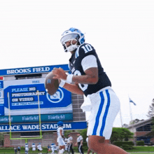 a football player with the number 10 on his jersey throws the ball