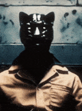 a man wearing a black cat mask and sunglasses