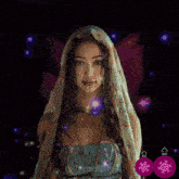 a woman with a veil on her head is surrounded by purple and pink flowers