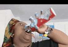 a woman is drinking from a can of ice cream while wearing a bandana and a watch .