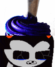 a cupcake with purple frosting and a drawing of a cat with sunglasses